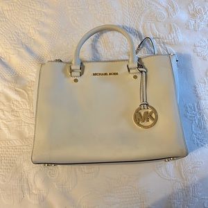 White Michael Kors purse.